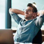 Young businessman wearing eyeglasses considering LASIK